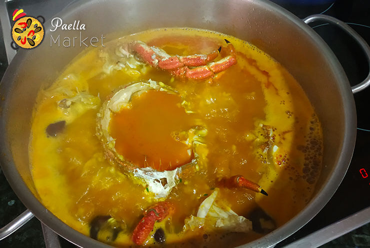 Seafood stew with rice boiling